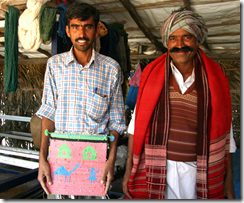 Tejsi Dhana Marwada (R) master Kharad weaver with his cousin Sumar, holding a weaving made from plastic bags. 